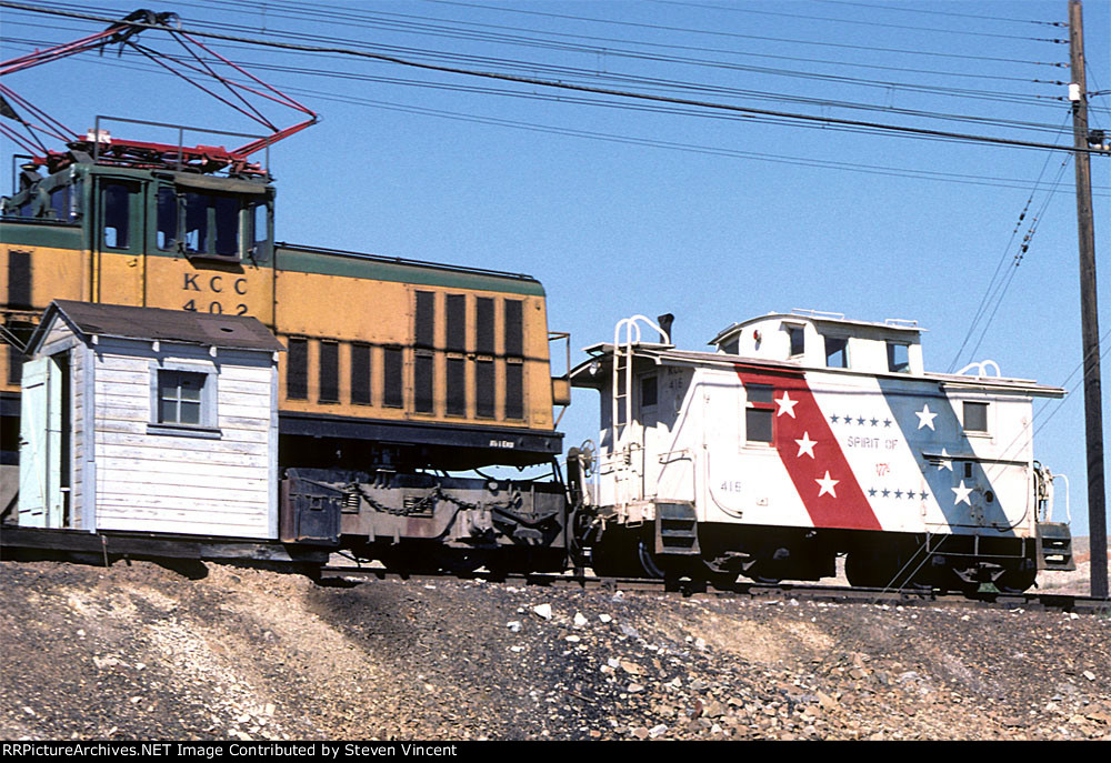 Kennectt Copper electric moves thr RWB Bicentennial caboose into position.